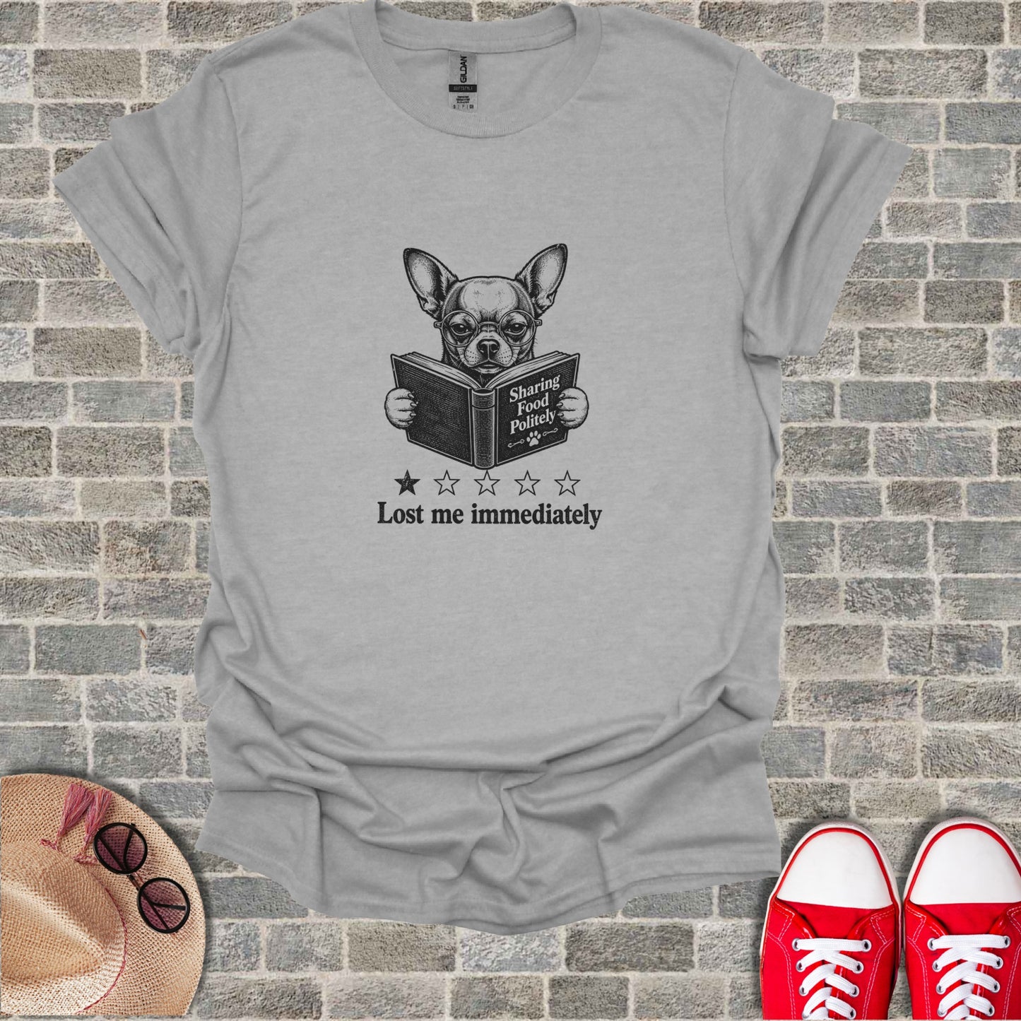 Chihuahua reading a book with "Lost me immediately" and stars on the t-shirt.