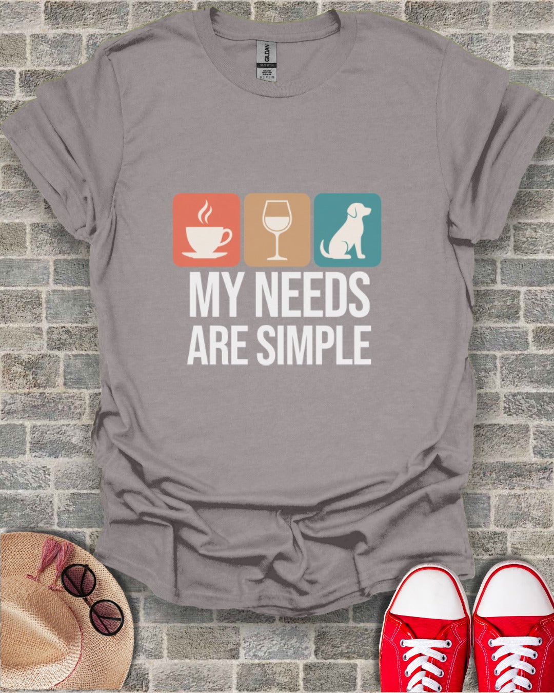 Gray t-shirt with coffee, wine glass, and dog icons; text reads "MY NEEDS ARE SIMPLE".