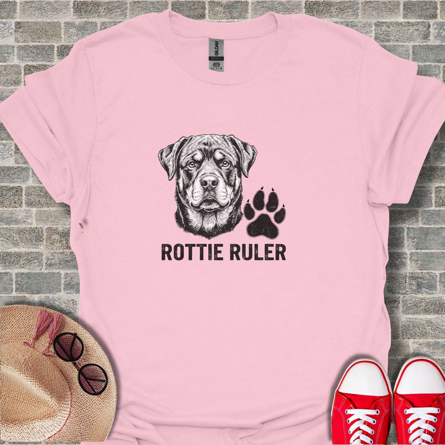 Pink t-shirt with a Rottweiler and paw print graphic.