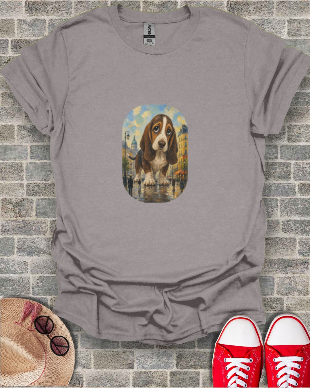 Gray t-shirt with a painting of a sad Basset Hound on a European street.