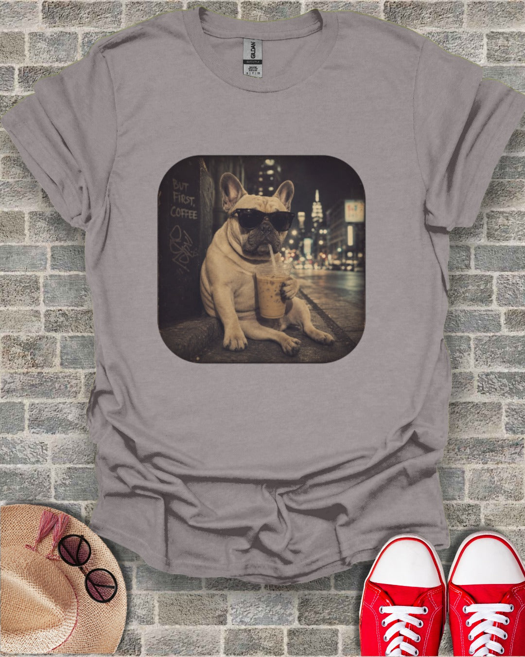 French bulldog in sunglasses drinks iced coffee with "But First, Coffee" text.