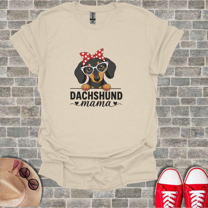 Dachshund mama graphic on cream t-shirt with red bow and glasses.