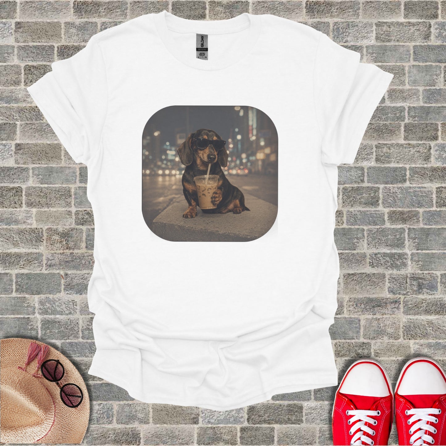 White t-shirt with a graphic of a dachshund wearing sunglasses sipping a drink.