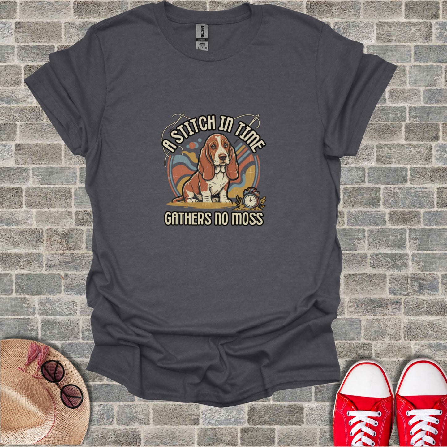 Dark gray t-shirt with "A stitch in time gathers no moss" and basset hound graphic.