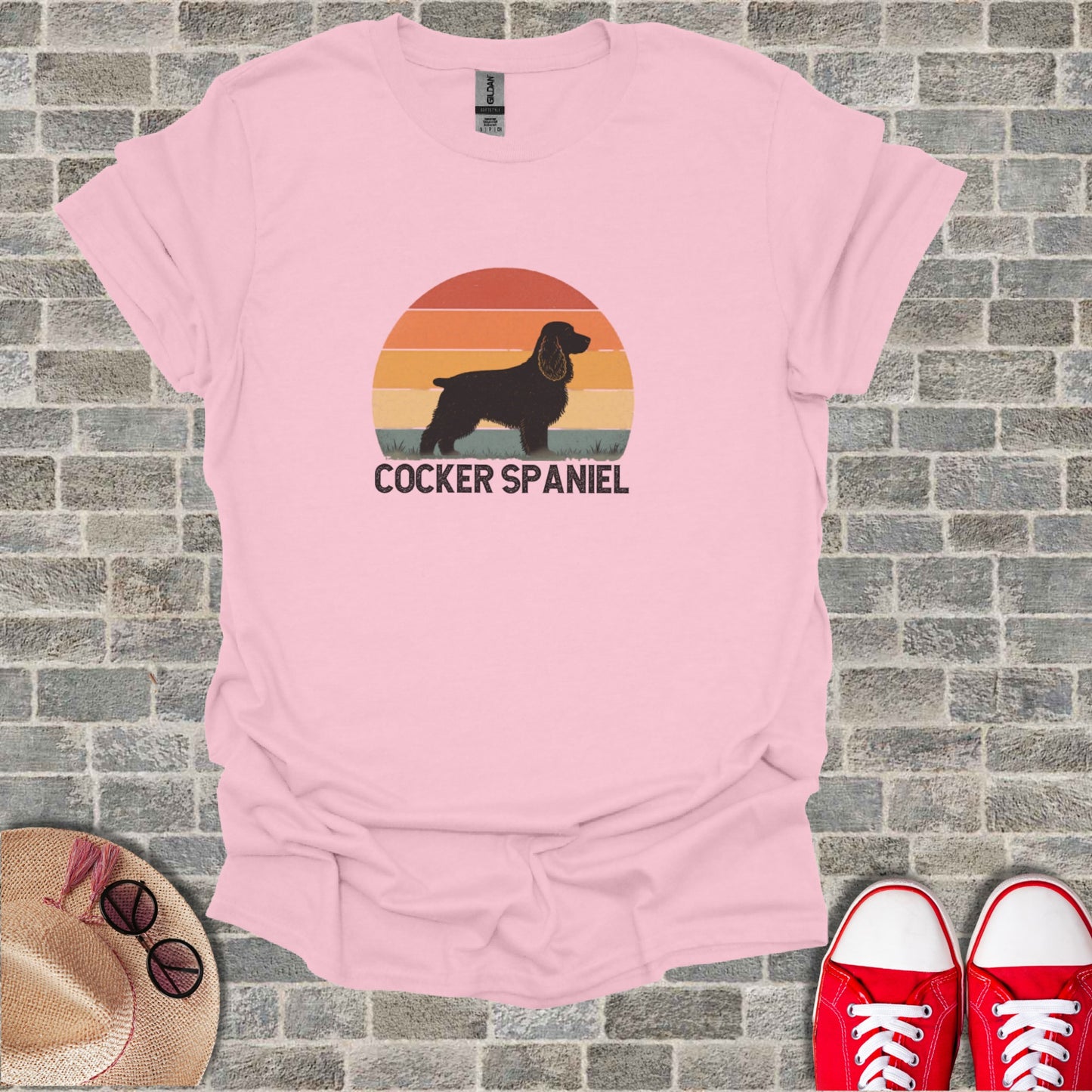 Pink t-shirt with a sunset graphic and "COCKER SPANIEL" text.