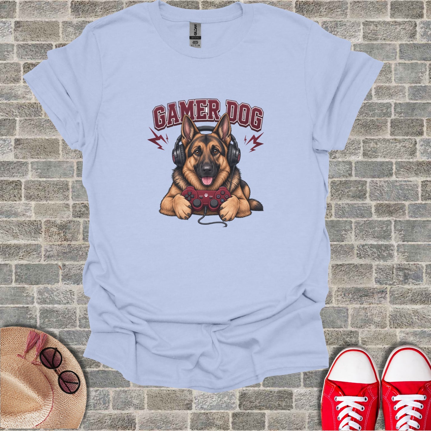 German Shepherd dog wearing headphones and playing video games on light blue t-shirt.