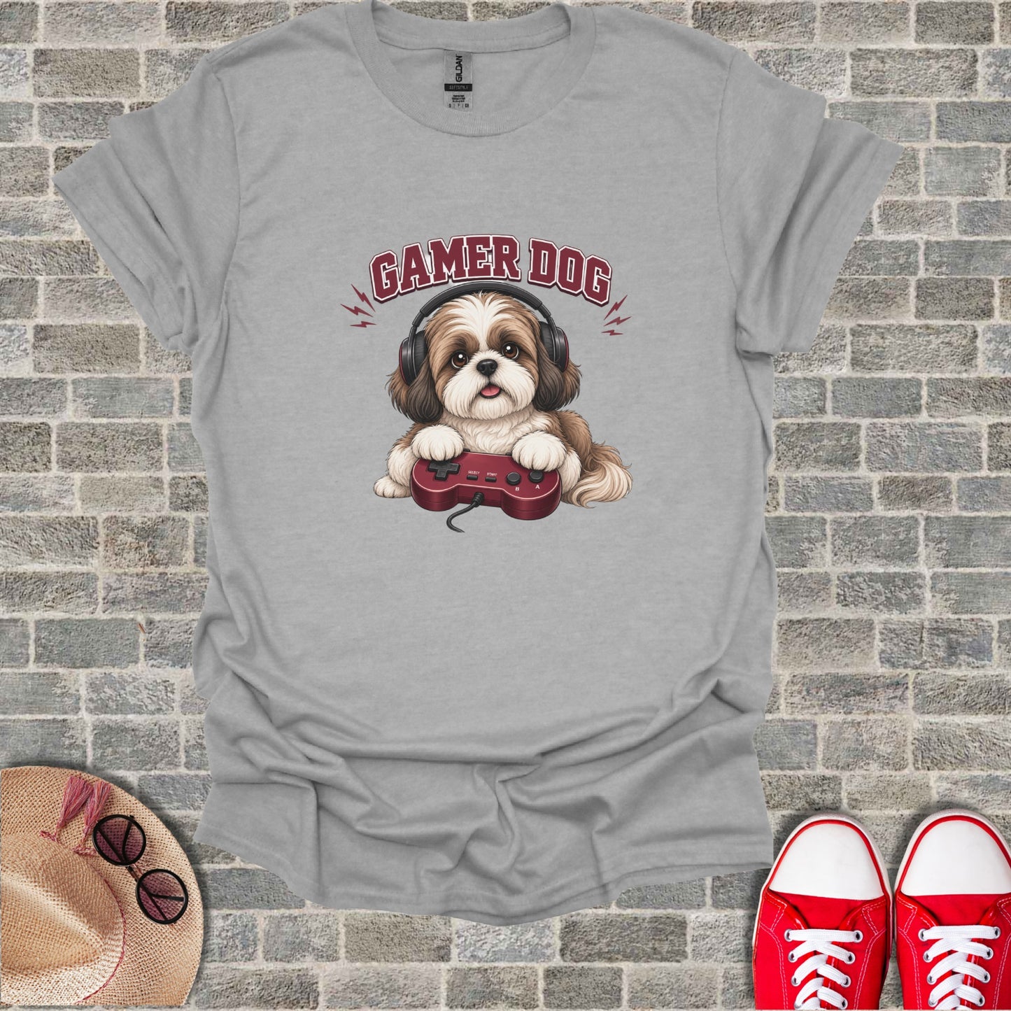 Grey t-shirt with a cartoon dog wearing headphones and holding a video game controller.