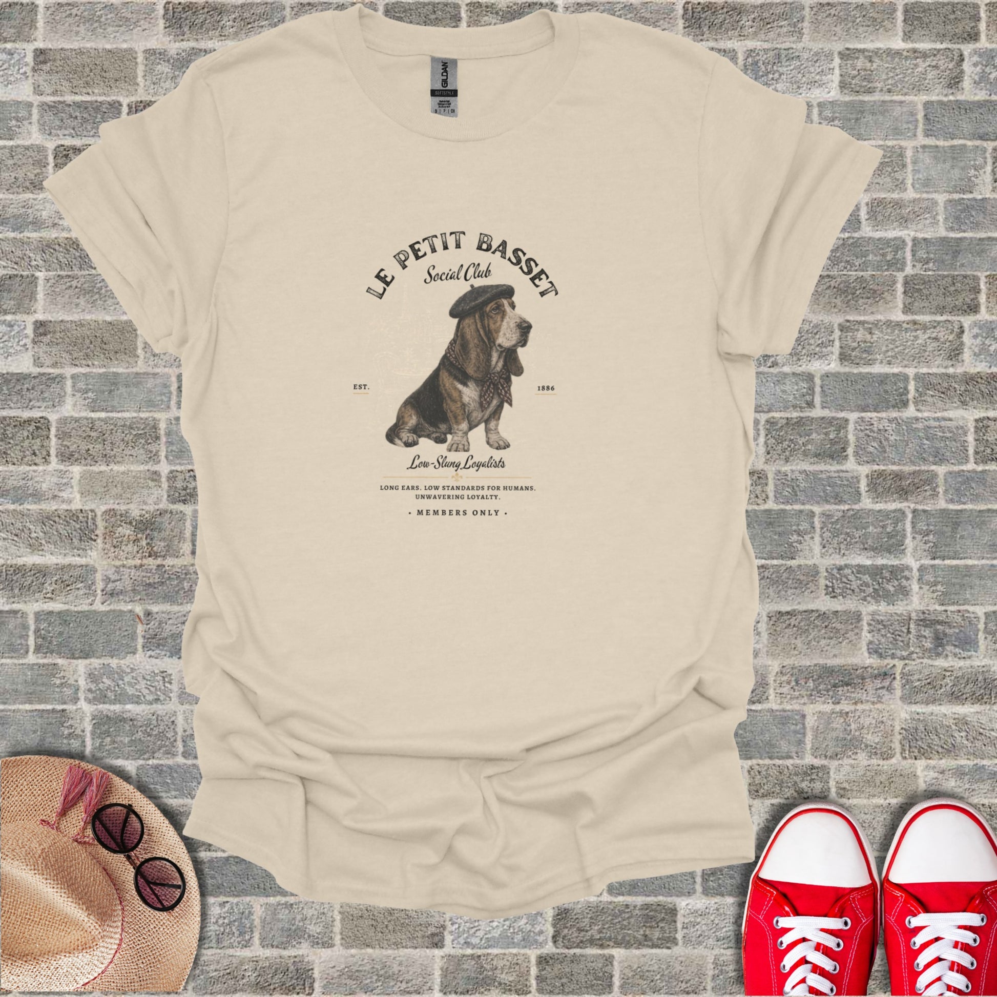 Cream t-shirt with "Le Petit Basset Social Club" logo featuring a basset hound wearing a beret.