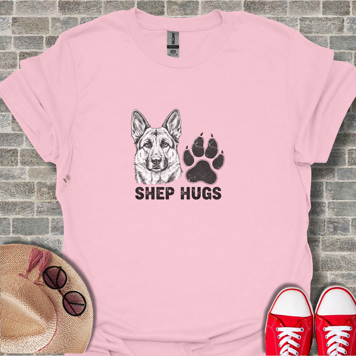 Pink t-shirt with "SHEPHUGS" text and German Shepherd dog paw print graphic.