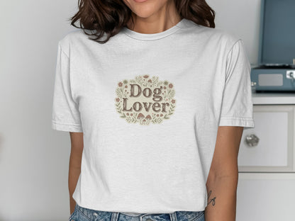 White t-shirt with "Dog Lover" text surrounded by flowers and mushrooms.