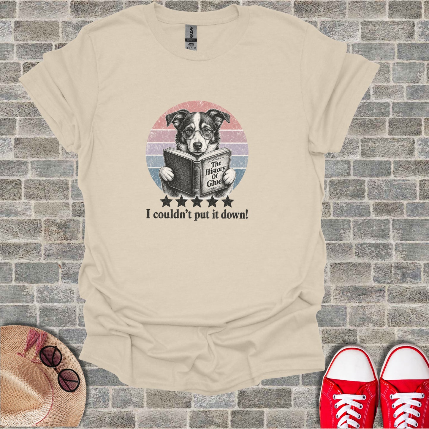 Dog wearing glasses reads "The History of Glue" on t-shirt.