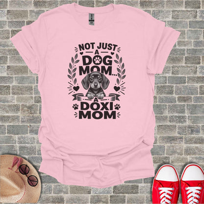 Pink t-shirt with graphic "Not Just A Dog Mom... A Doxi Mom" and dachshund.