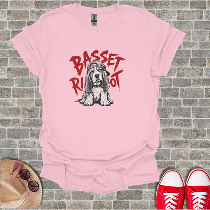 Pink t-shirt with a sketched basset hound wearing a hat, text "Basset Riot".