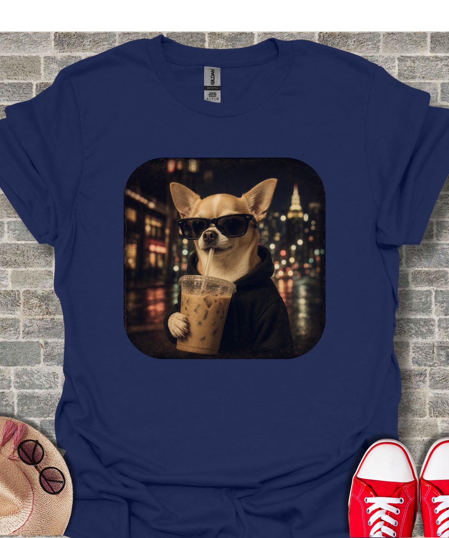 Chihuahua in sunglasses wearing a hoodie drinks iced coffee with city lights background.