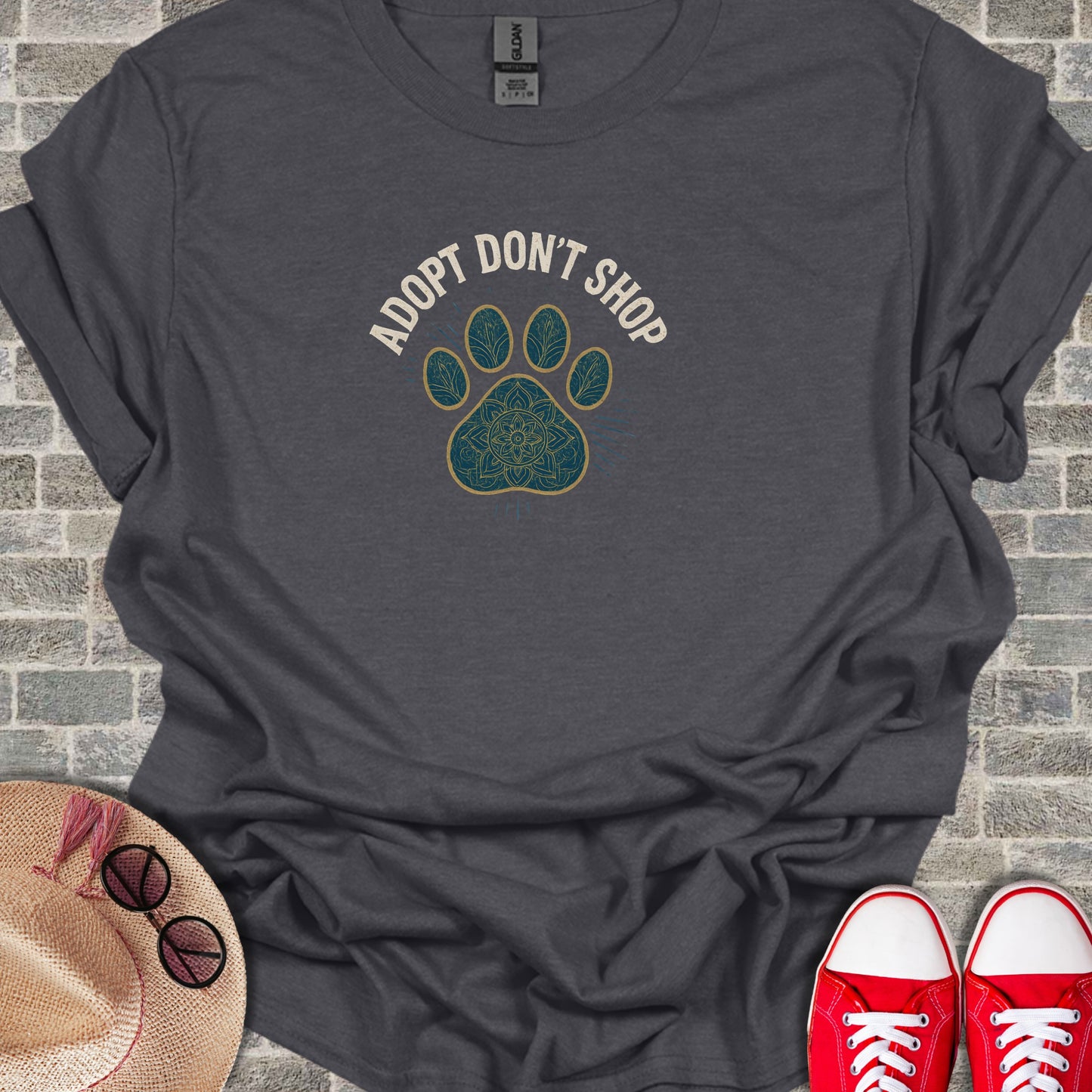 Dark gray t-shirt with "ADOPT DON'T SHOP" text and paw print design.