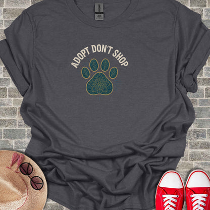 Dark gray t-shirt with "ADOPT DON'T SHOP" text and paw print design.
