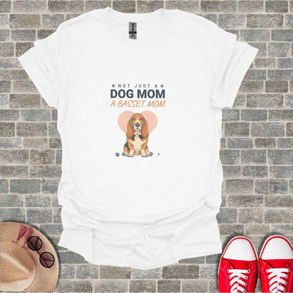 White t-shirt with a Basset Hound graphic and the text "NOT JUST A DOG MOM A BASSET MOM"