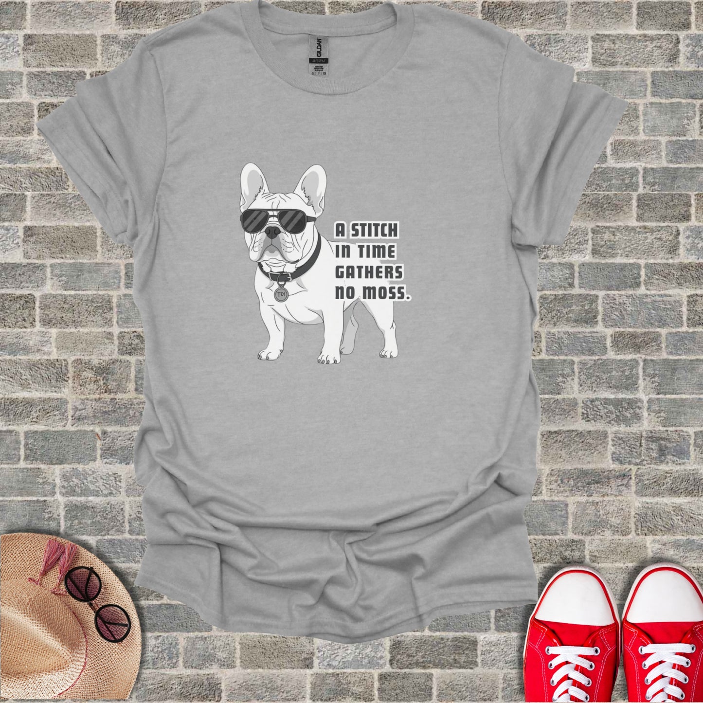 French Bulldog wearing sunglasses with text "A STITCH IN TIME GATHERS NO MOSS".