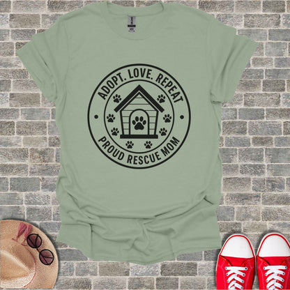Light green t-shirt with black "Adopt. Love. Repeat. Proud Rescue Mom." graphic.