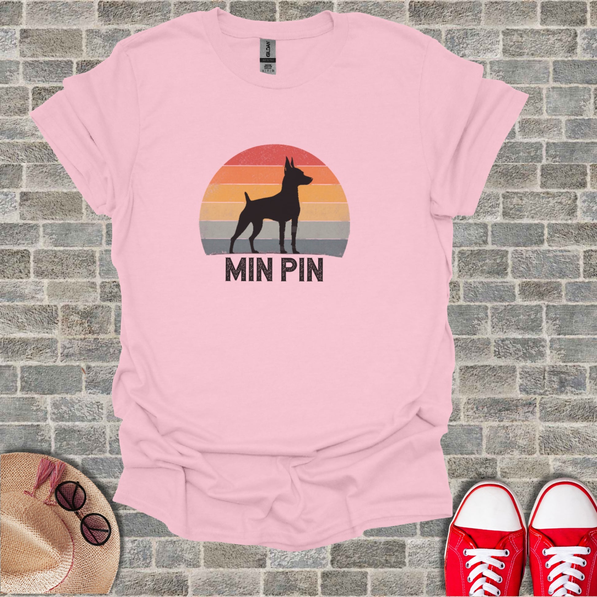 Pink t-shirt with a black silhouette of a Miniature Pinscher against a sunset with "MIN PIN" text.