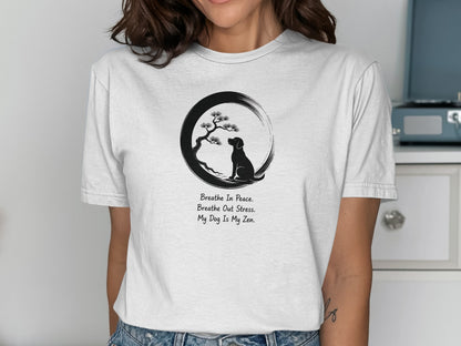 Woman wearing a t-shirt with a dog meditating under a tree, with text.