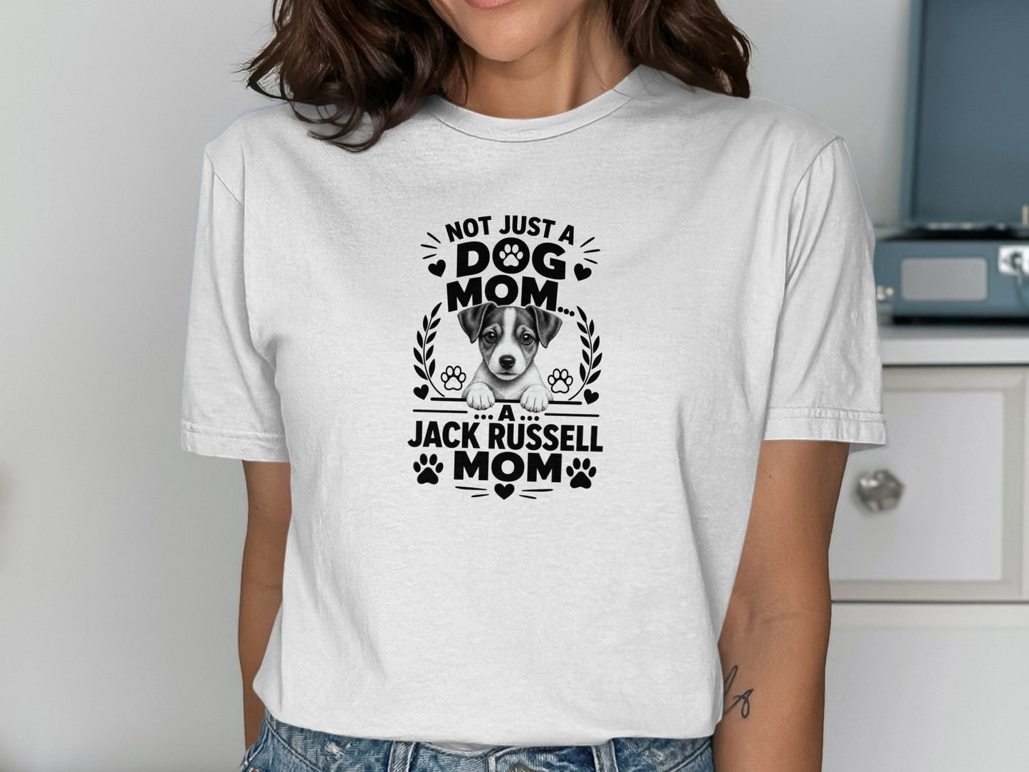 White t-shirt with black text and illustration of a Jack Russell puppy and paw prints.