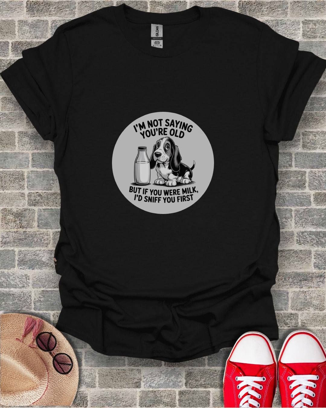 T-shirt with a cartoon dog and milk bottle, text reads "I'm not saying you're old".