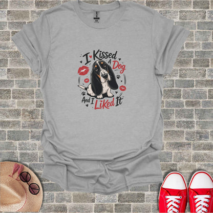 Gray t-shirt with a Basset Hound wearing lipstick and text "I Kissed A Dog And I Liked It".