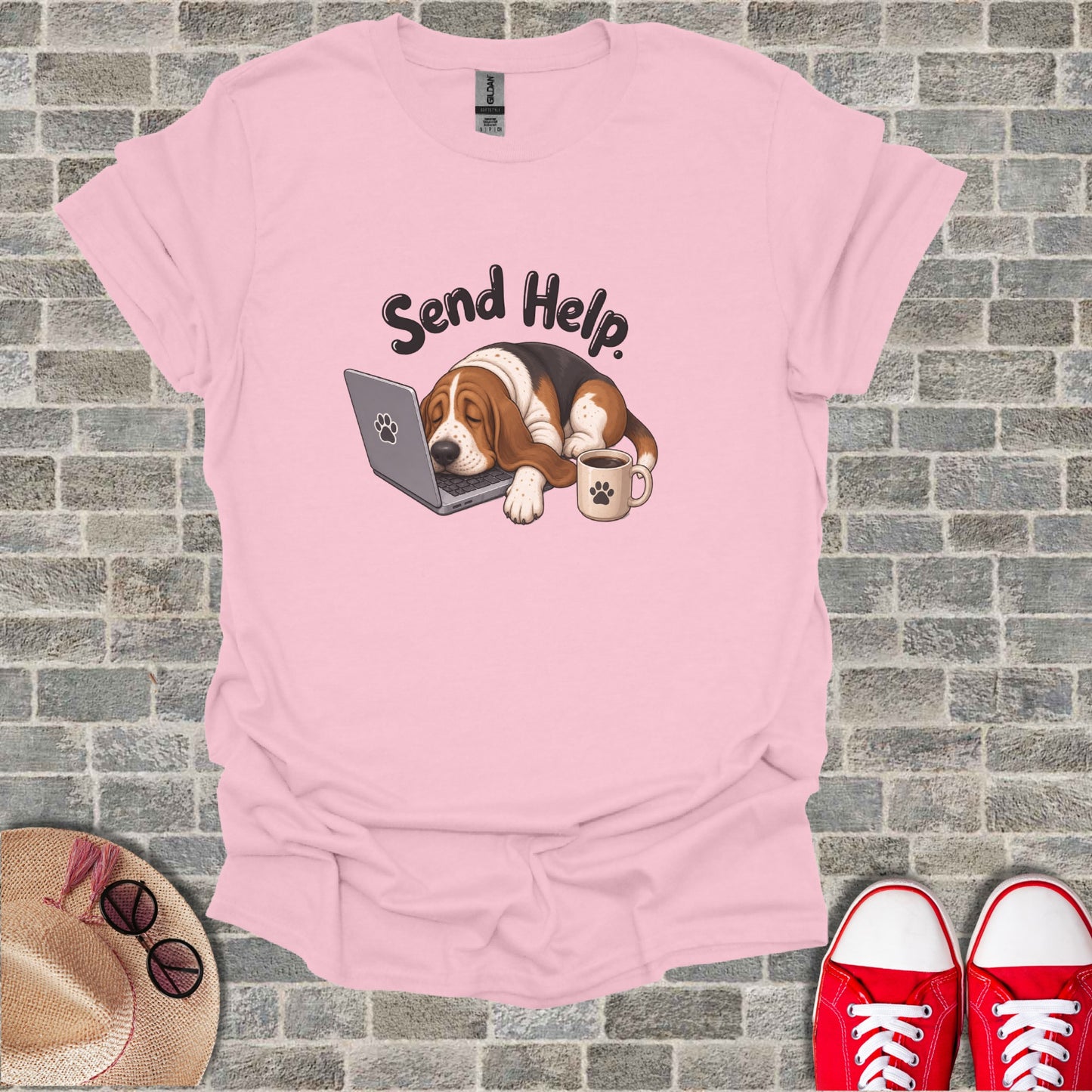 Pink t-shirt with cartoon basset hound sleeping on a laptop, text "Send Help".