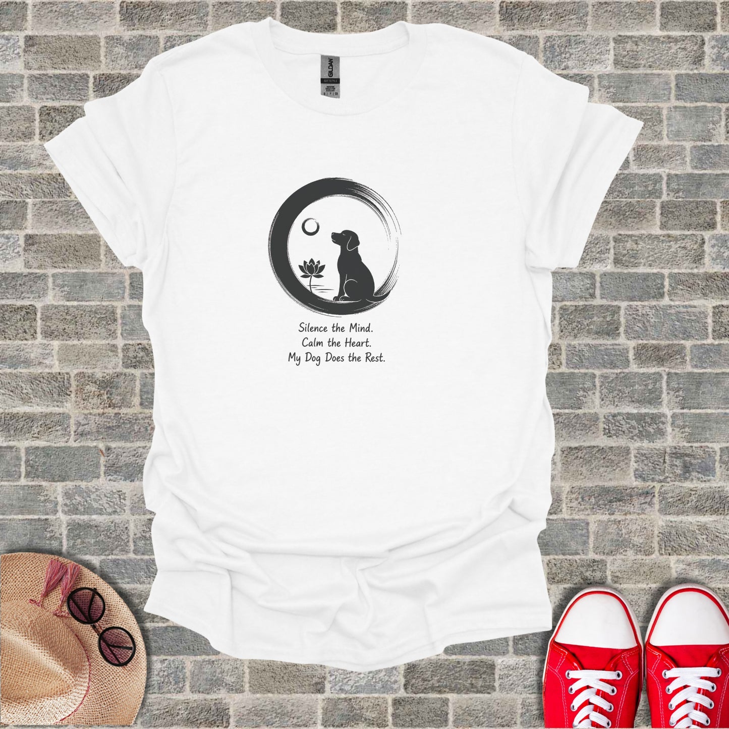 White t-shirt with a black dog silhouette in a circle, lotus flower, and inspirational text.