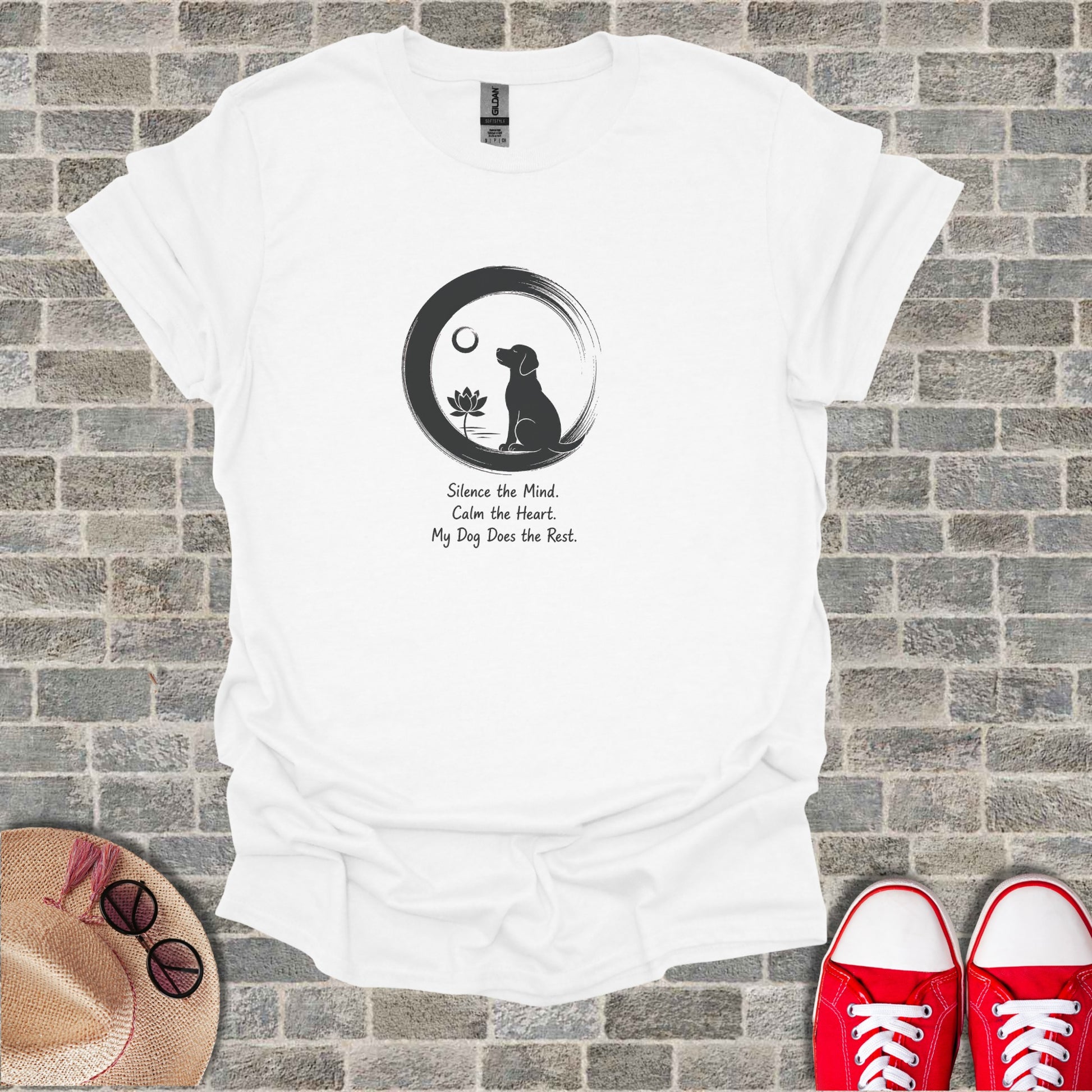 White t-shirt with a black dog silhouette in a circle, lotus flower, and inspirational text.