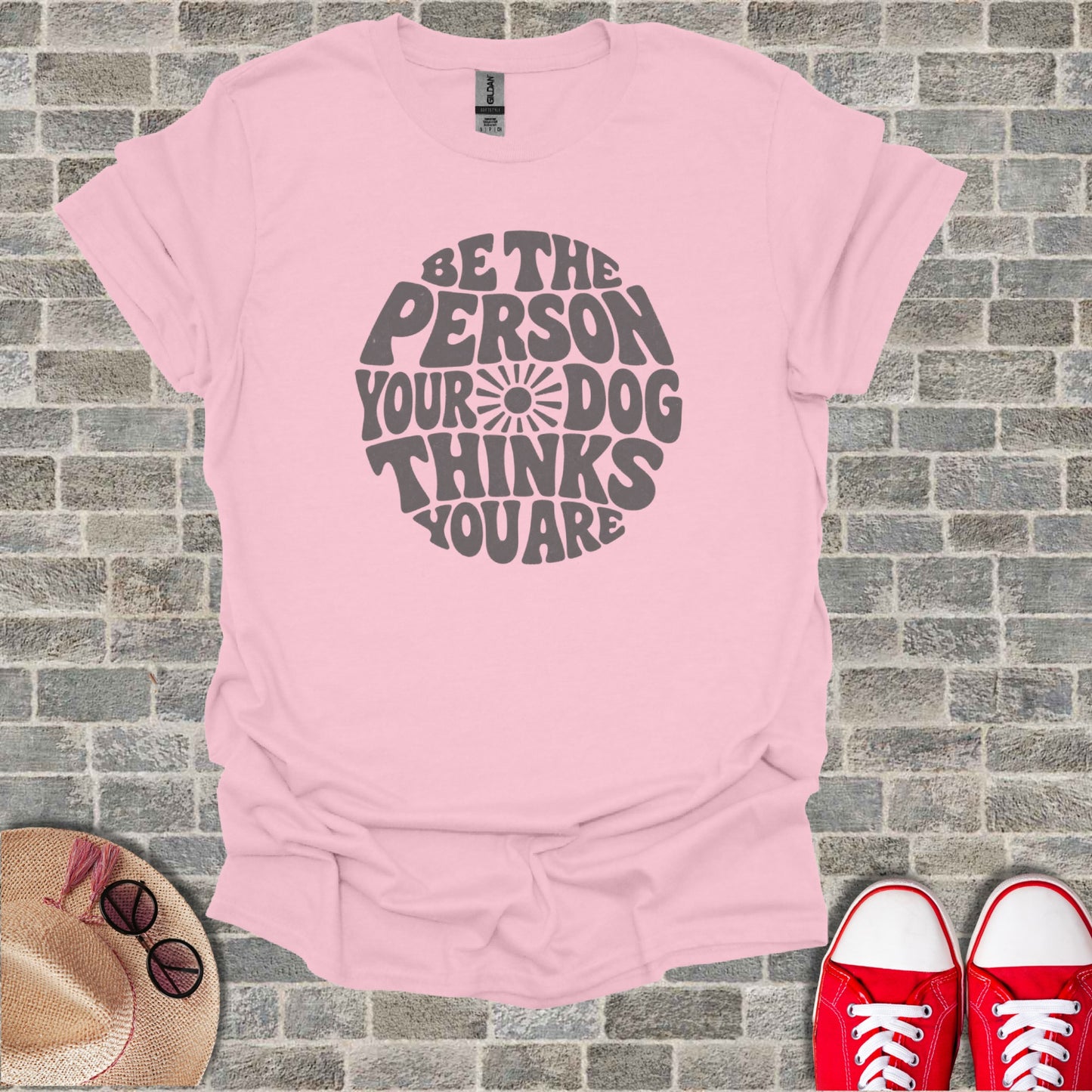 Pink t-shirt with "Be the person your dog thinks you are" text.