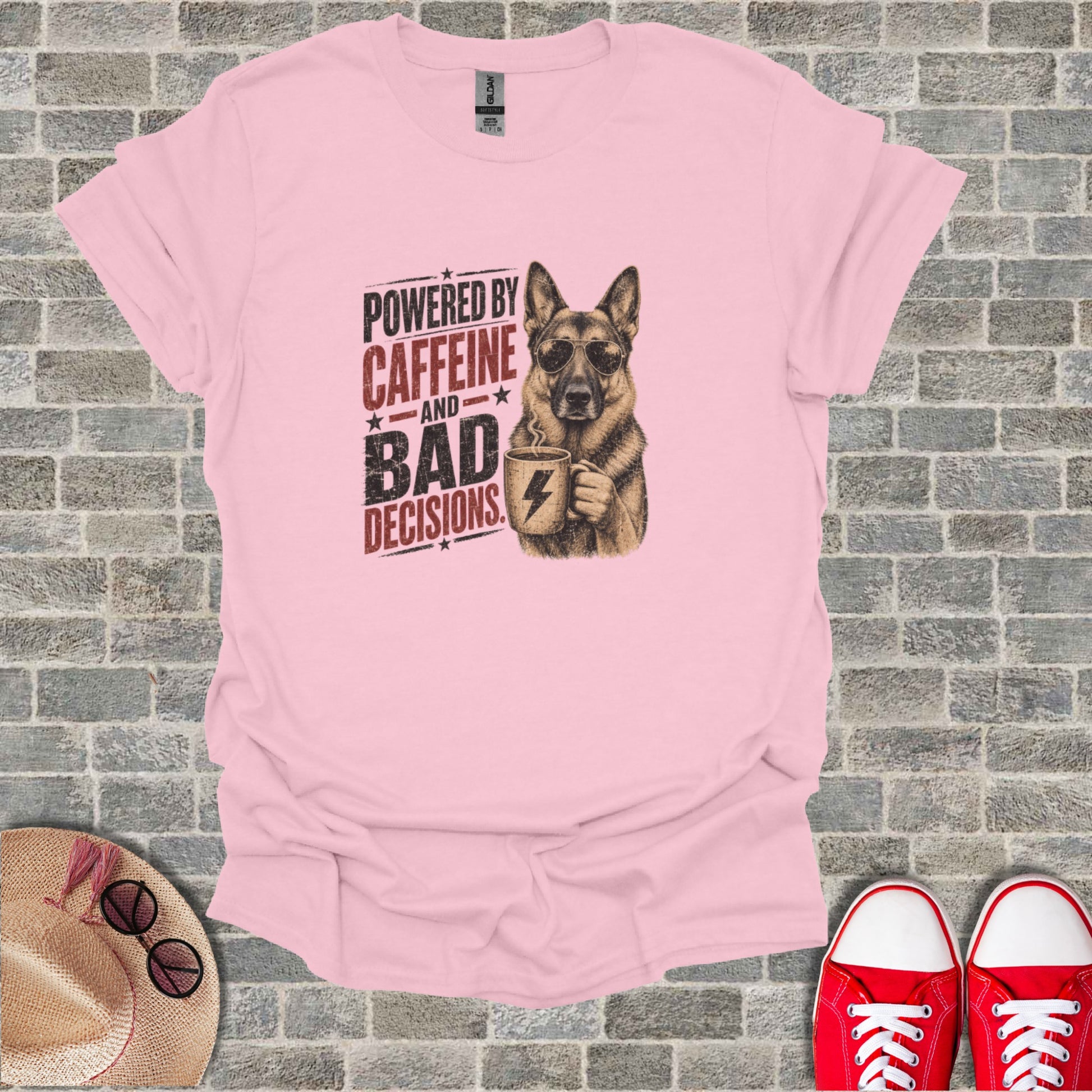 German Shepherd wearing sunglasses holds coffee mug; text says "Powered by caffeine and bad decisions".