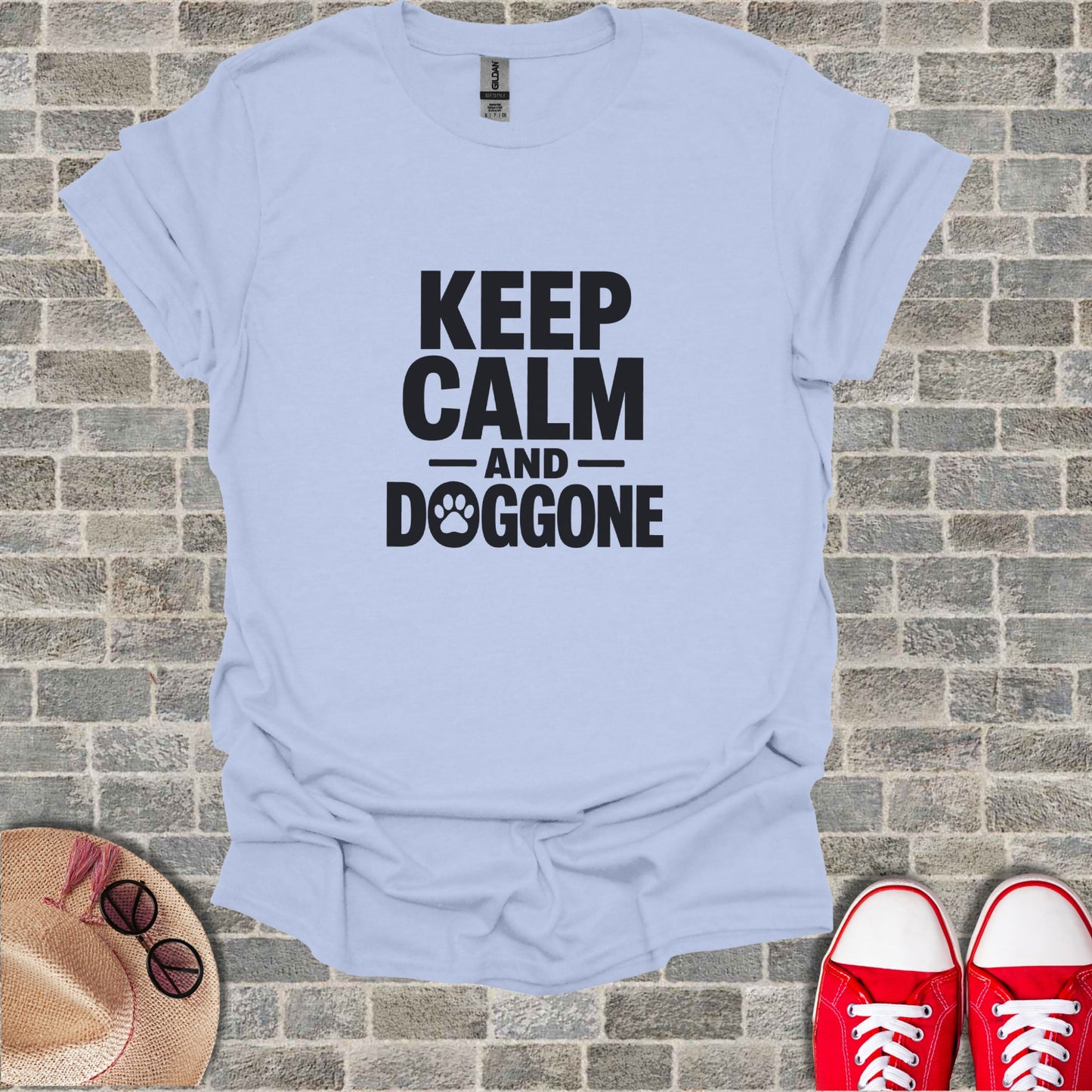 Light blue t-shirt with "KEEP CALM AND DOGGONE" text and paw print.