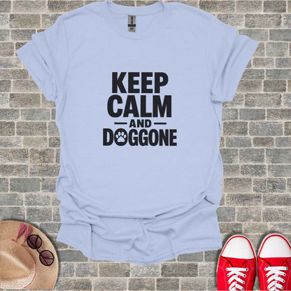Light blue t-shirt with "KEEP CALM AND DOGGONE" text and paw print.