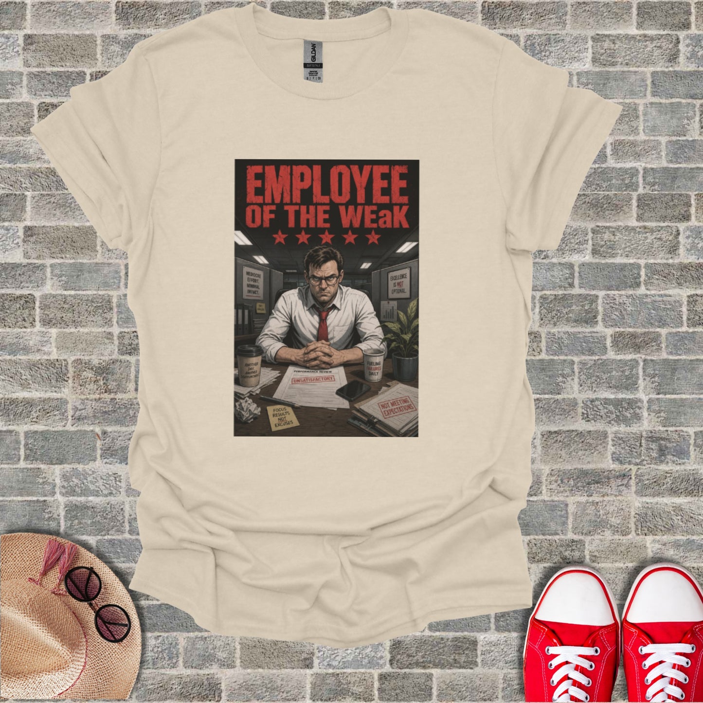 T-shirt with "Employee of the Weak" text and stars, plus desk items.