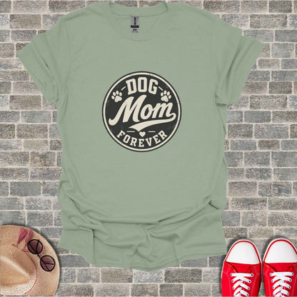 Green t-shirt with "Dog Mom Forever" text and paw print design.