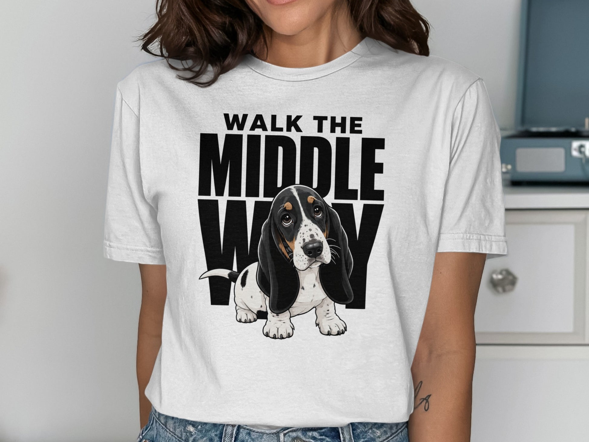Basset hound wearing a t-shirt that says "WALK THE MIDDLE WAY".