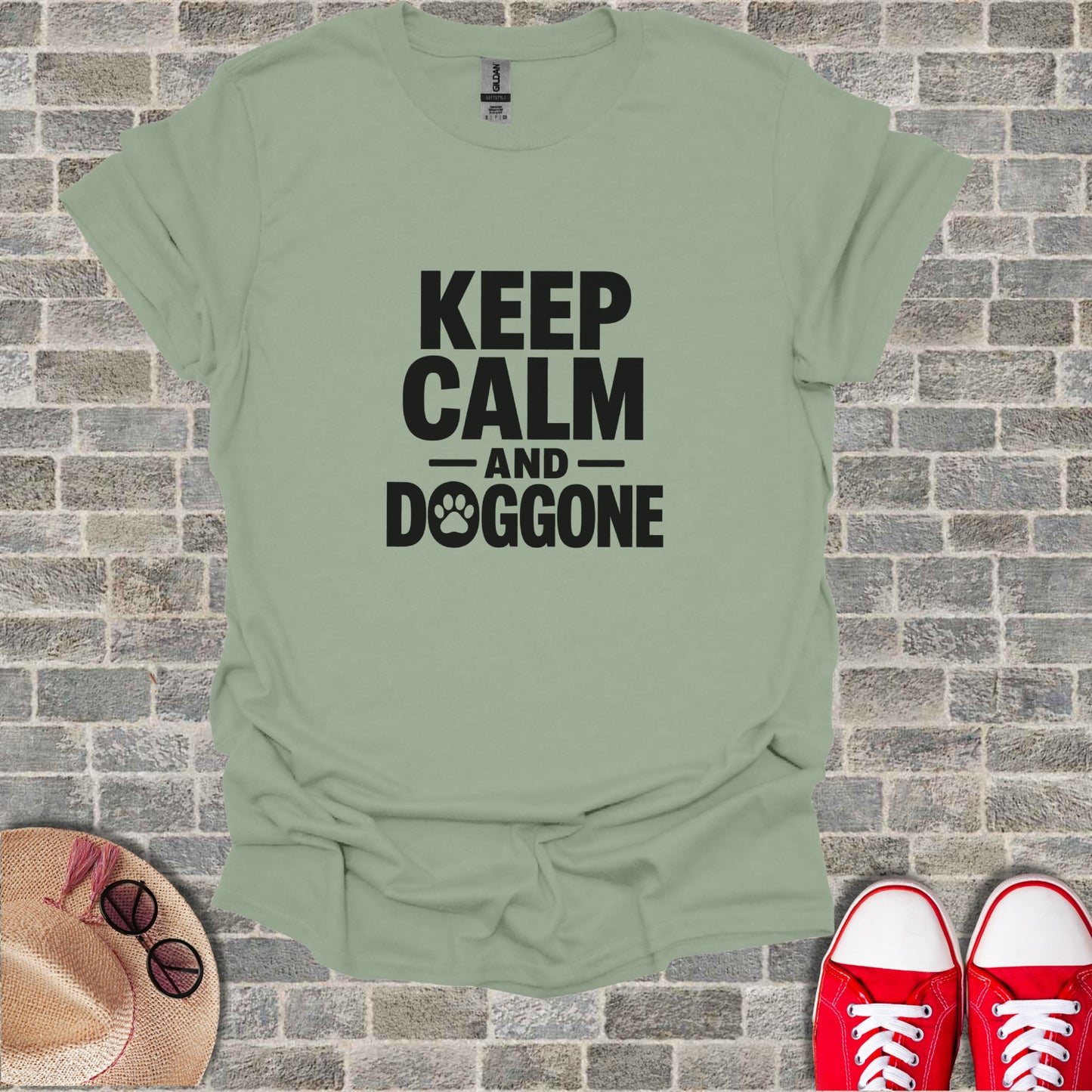 T-shirt with "KEEP CALM AND DOGGONE" text and paw print design.