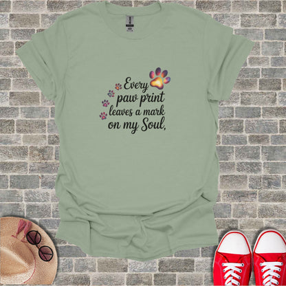 T-shirt with "Every paw print leaves a mark on my Soul" text and paw print graphics.