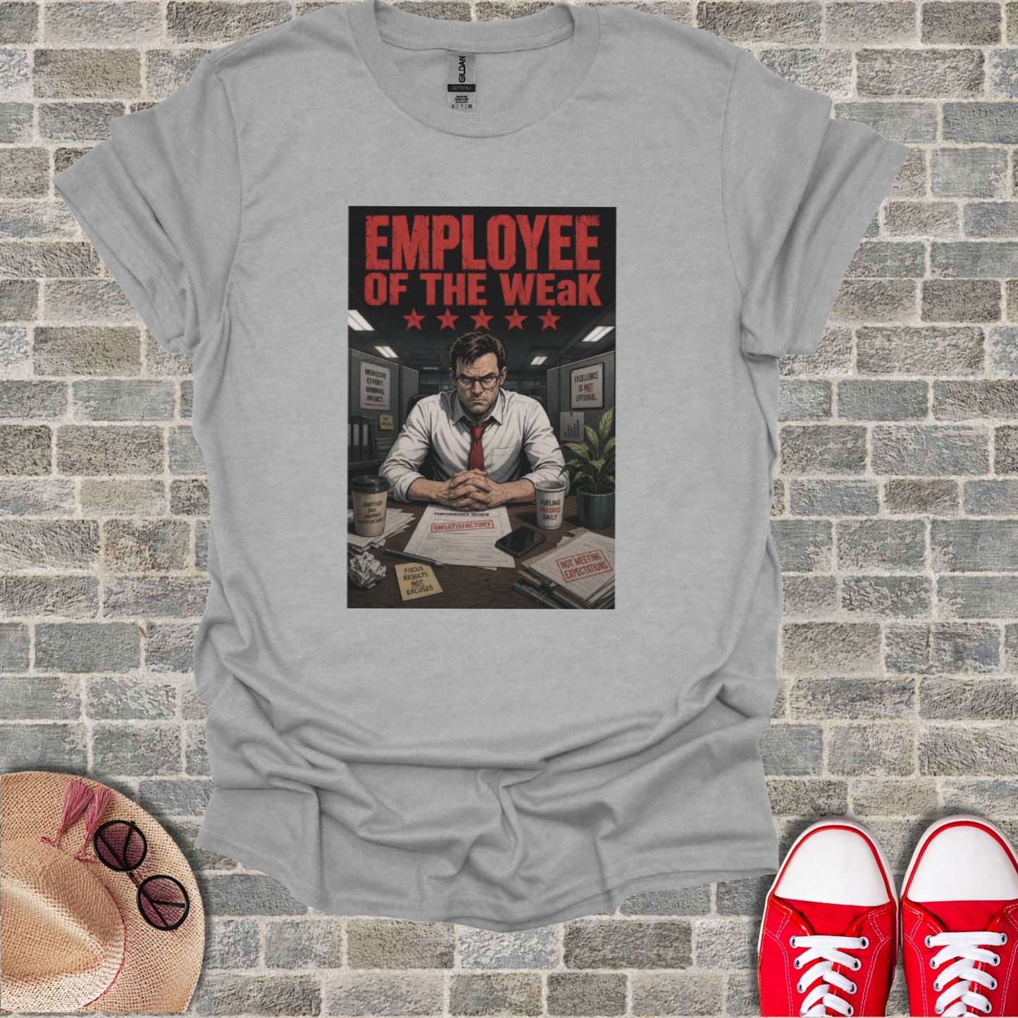 T-shirt graphic: "Employee of the Weak" with office scene and motivational phrases.