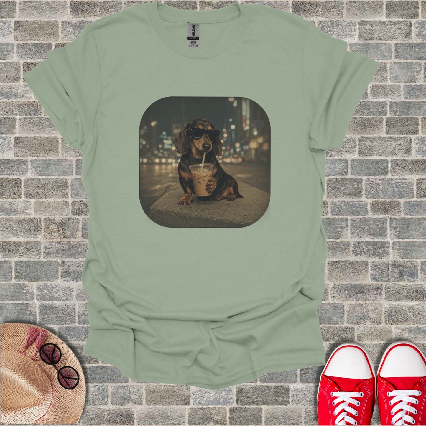Dachshund wearing sunglasses drinks from a coffee cup on a city street.