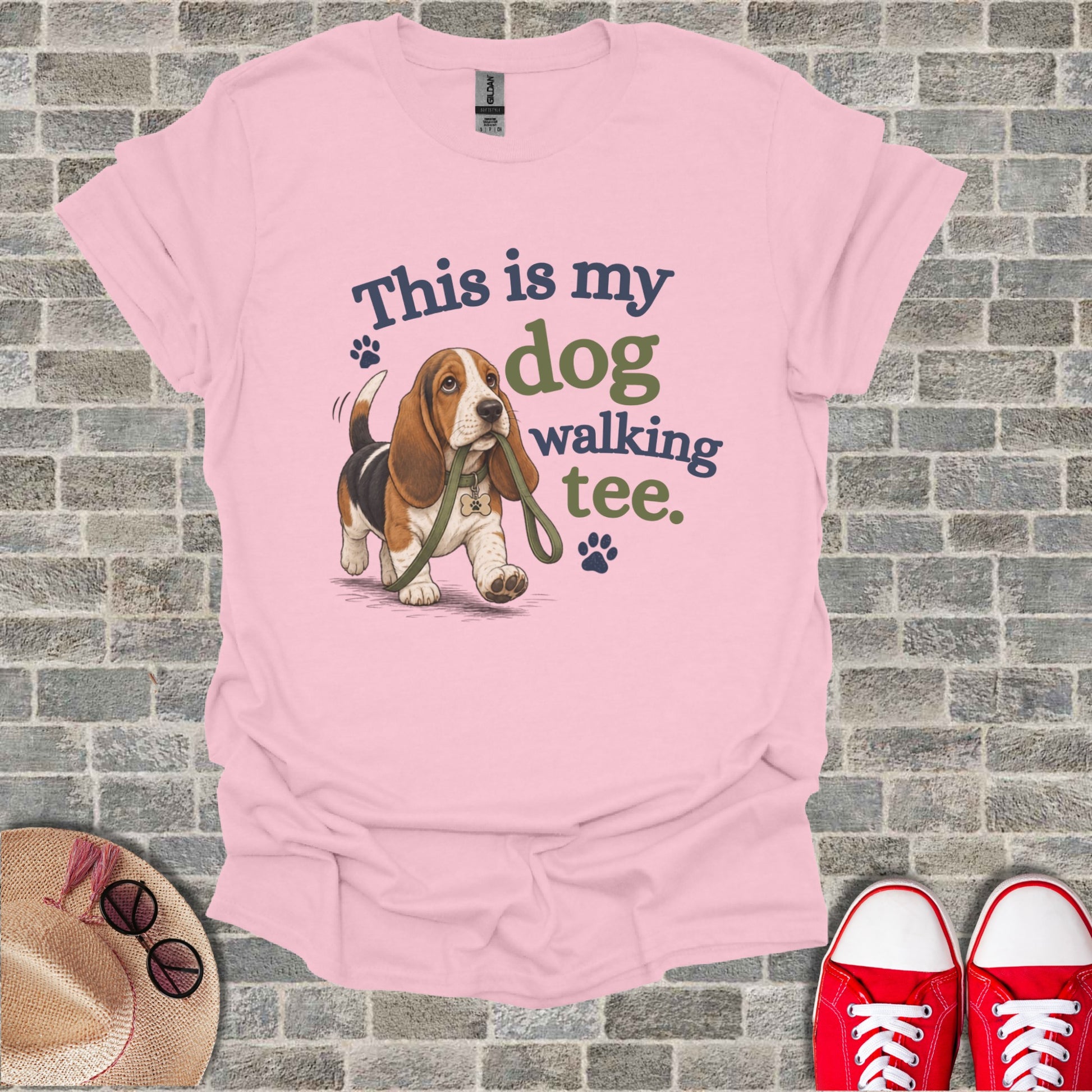Basset hound on leash with "This is my dog walking tee" text.