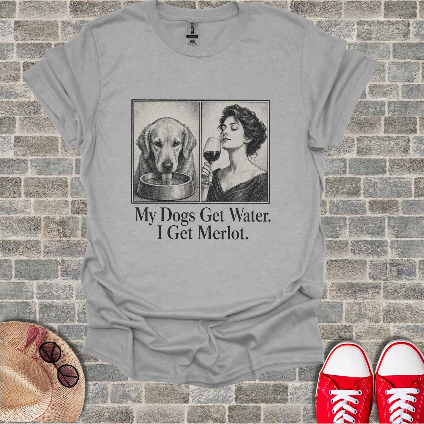Light gray t-shirt with sketch of dog drinking and woman drinking merlot, text reads "My Dogs Get Water. I Get Merlot."