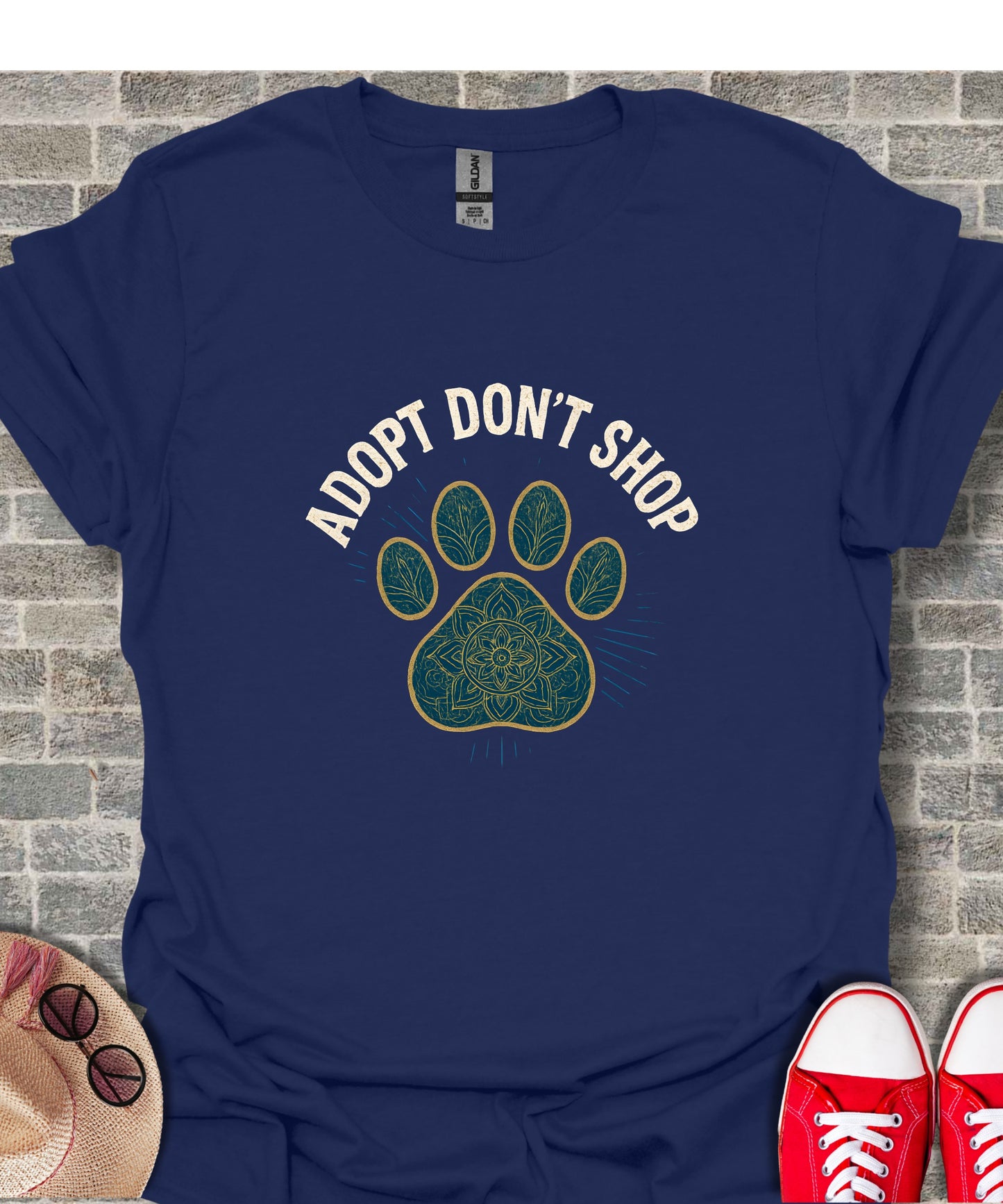 Navy t-shirt with "Adopt Don't Shop" text and paw print graphic.