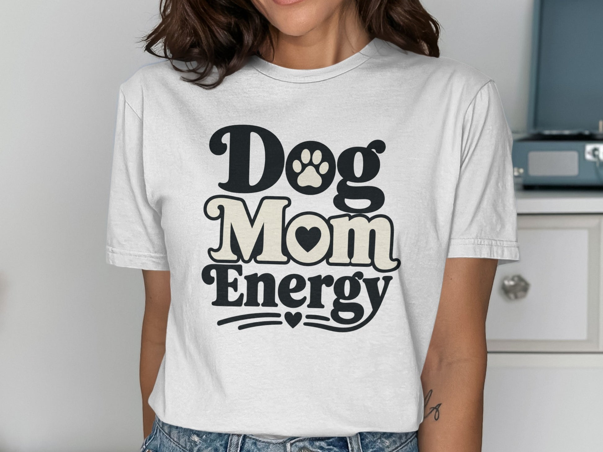 White t-shirt with "Dog Mom Energy" text, heart, and paw print.