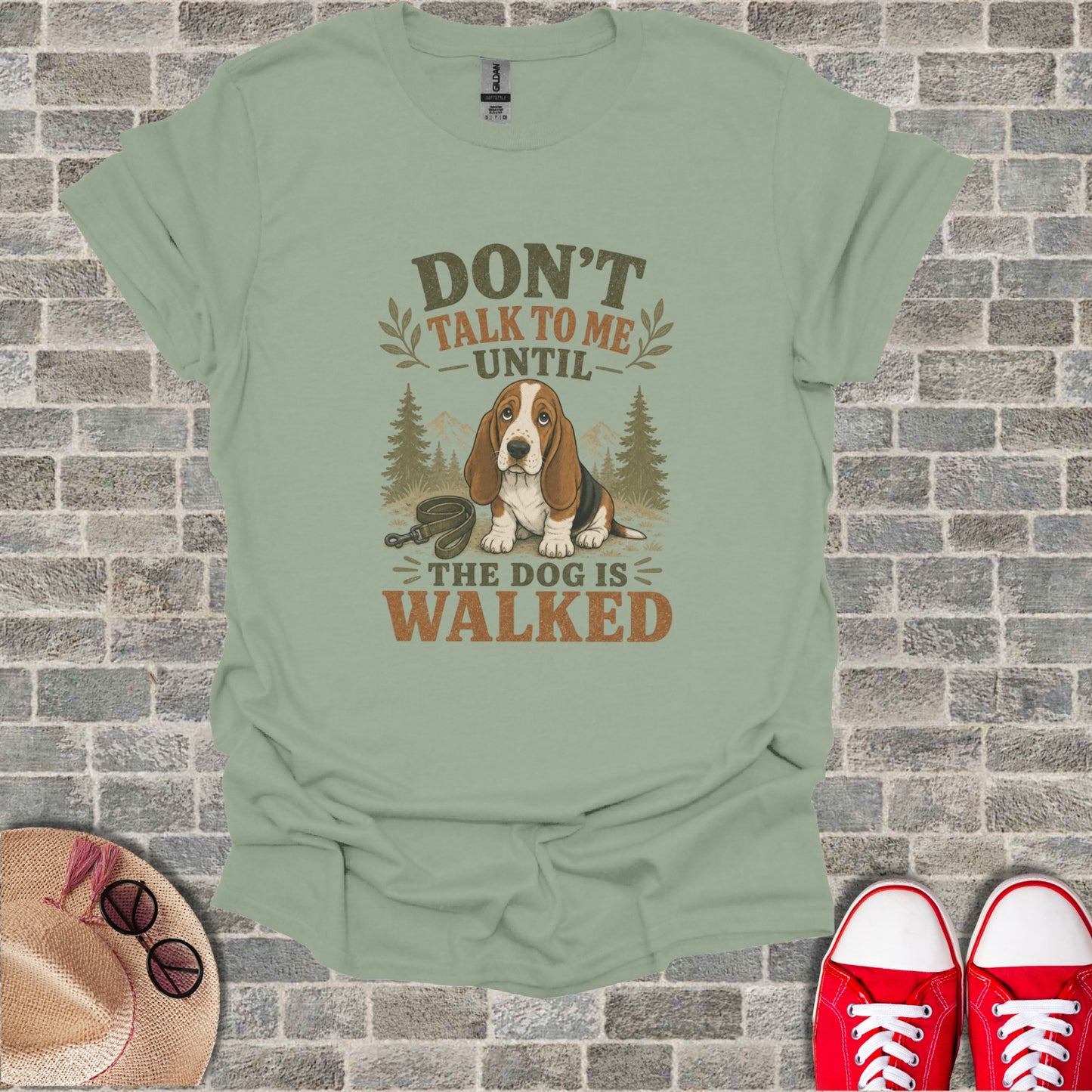Basset hound wearing a bandana, text reads "Don't talk to me until the dog is walked."