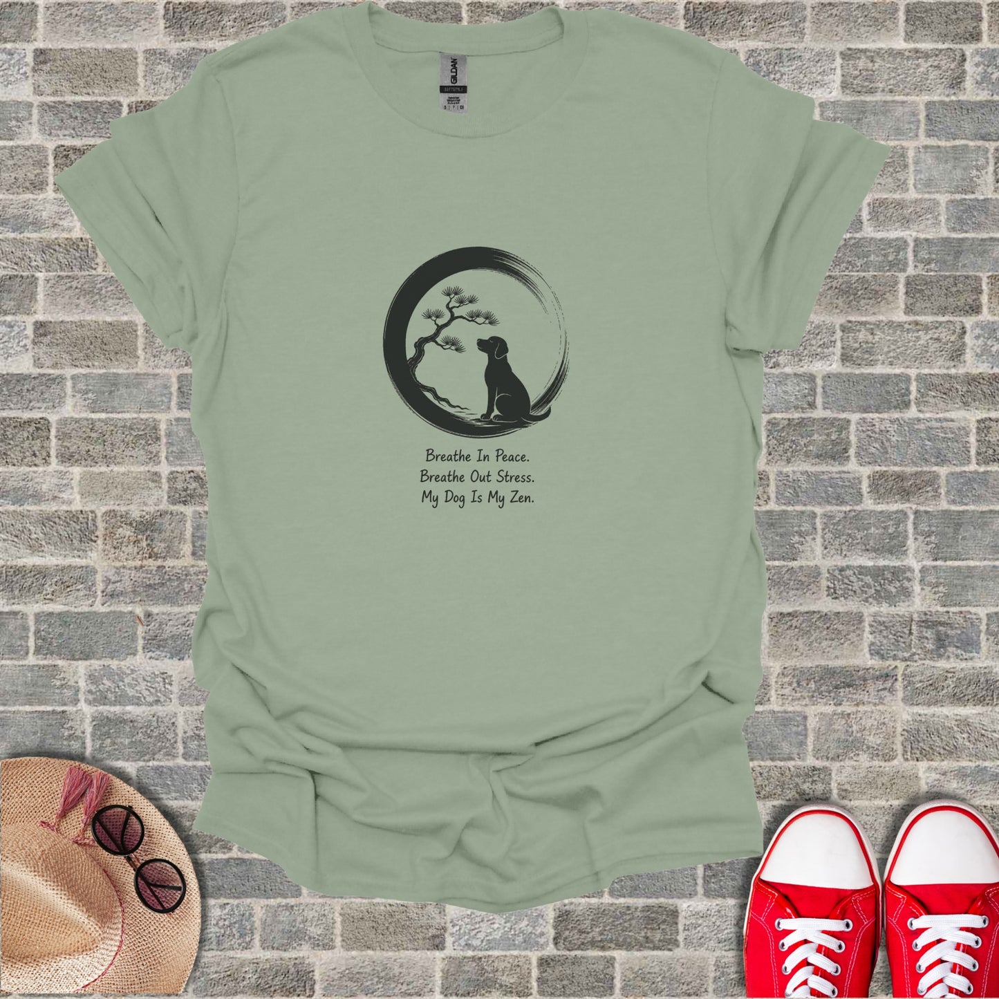 Light green t-shirt with dog silhouette, tree, and Zen quote.