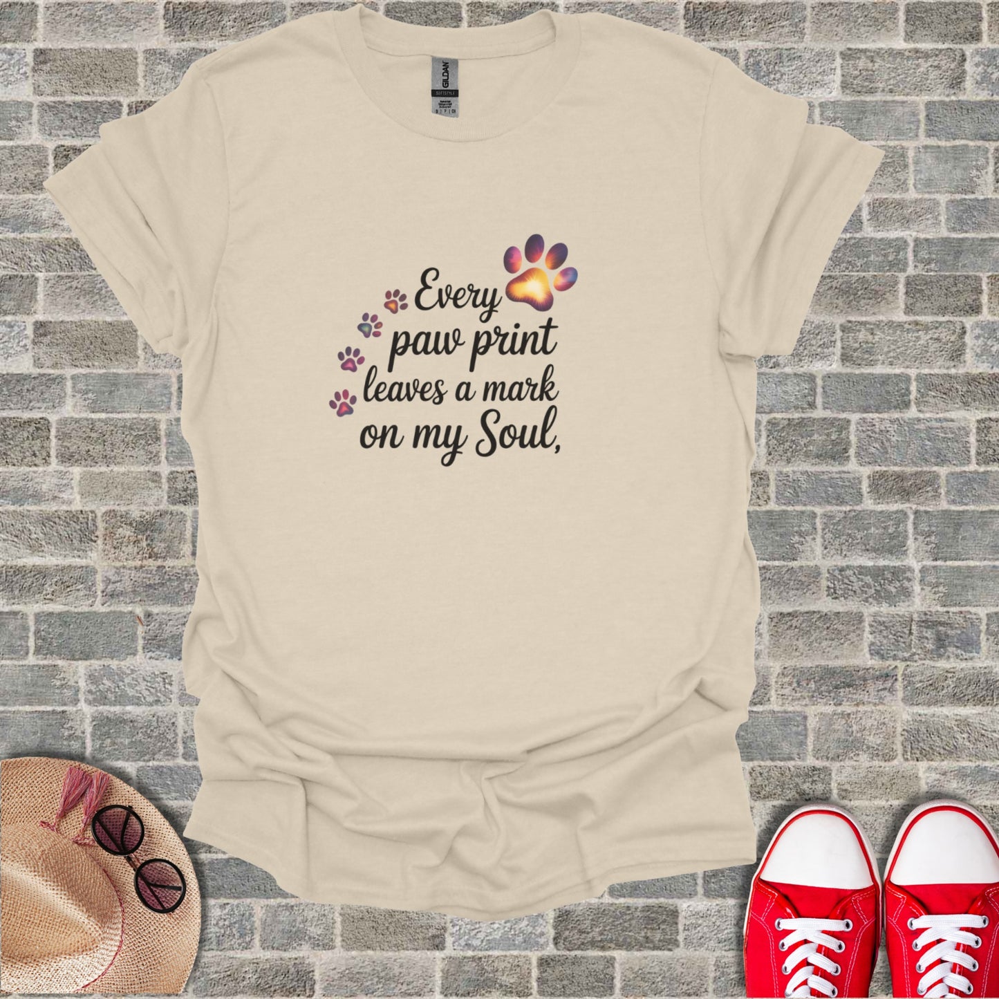Cream t-shirt with "Every paw print leaves a mark on my Soul" text and paw prints.