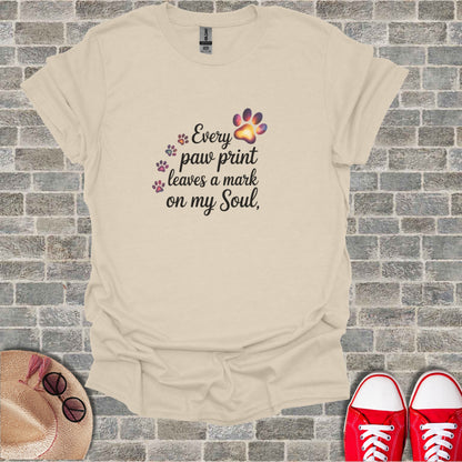 Cream t-shirt with "Every paw print leaves a mark on my Soul" text and paw prints.